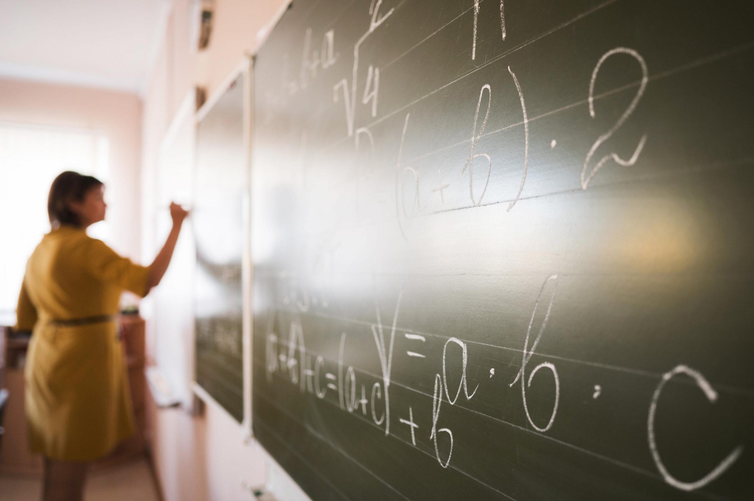 portrait-teacher-writing-on-chalkboard-scaled Un error hace que Educación repita las oposiciones